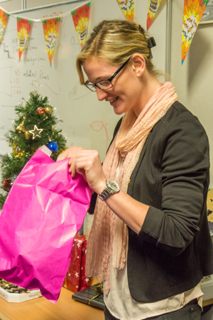 Claire unwraps her Secret Santa gift