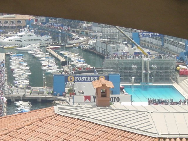 A racing car passing under the Fosters banner