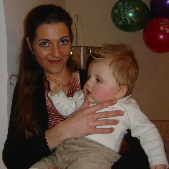 Coralie holding Alexis, trying to have him look at his mum.