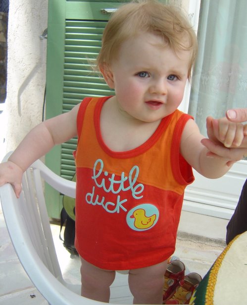 Alexis standing on an armchair