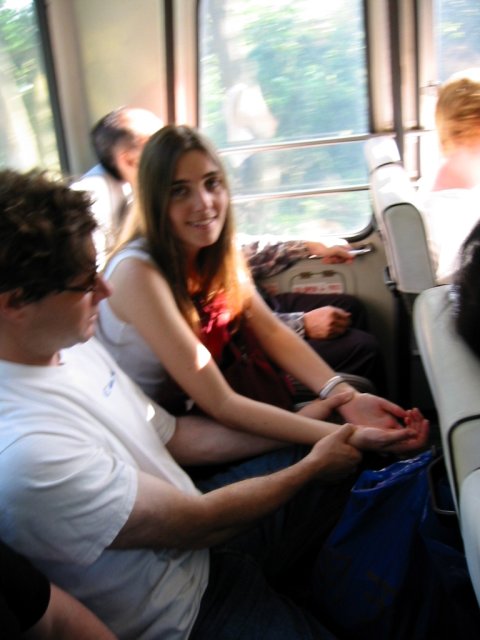 Ian and Coralie in a bus in Hong Kong, Ian in a attempt at curing Coralie's headache by pressing her wrists