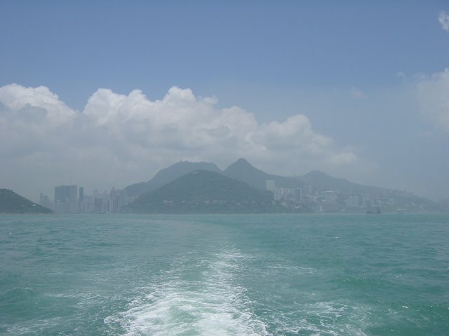 HK island in the fog from the distance of a ferry boat