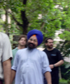 Out of focus picture of a smiling man wearing a turban, Ian and Daniel just behind
