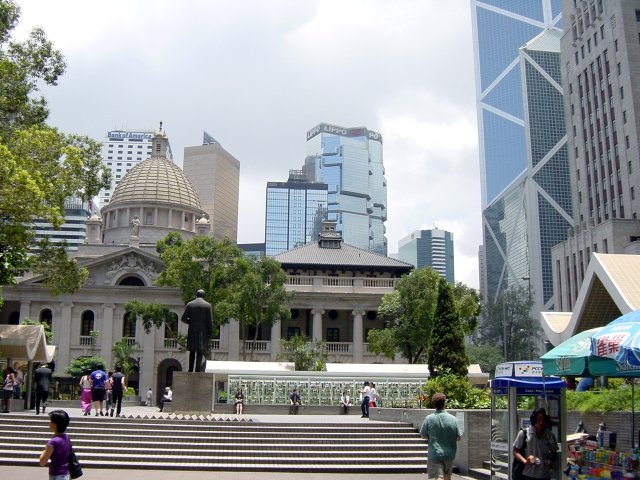 Esplanade with statue, fountains, building with dome an surrounded by glass scyscrapers