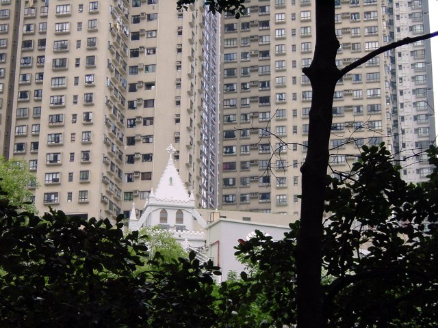 Chruch in front of huge and large blocks of flats