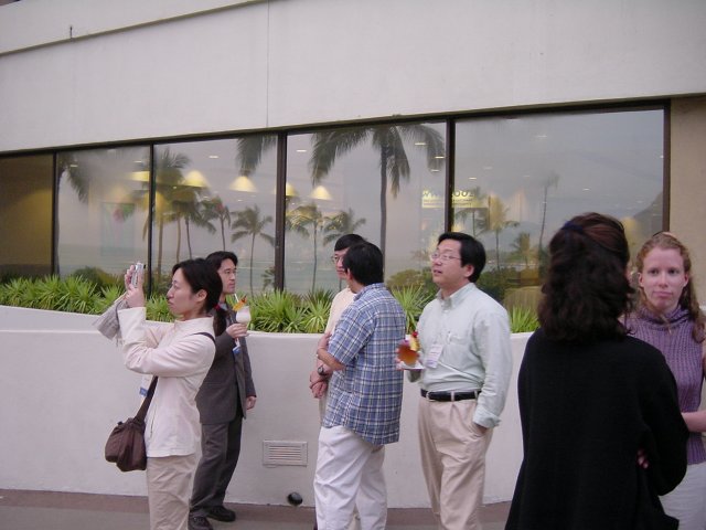 Saeko taking a picture of the rainbow, Japanese folks behind, Christelle and Nicole chatting on the right