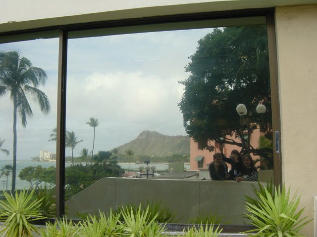 Reflection of Carine, Coralie, Yves and Diamond Head on a window