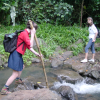 Christelle holding the stick to cross the stream, Caroline, Daniel