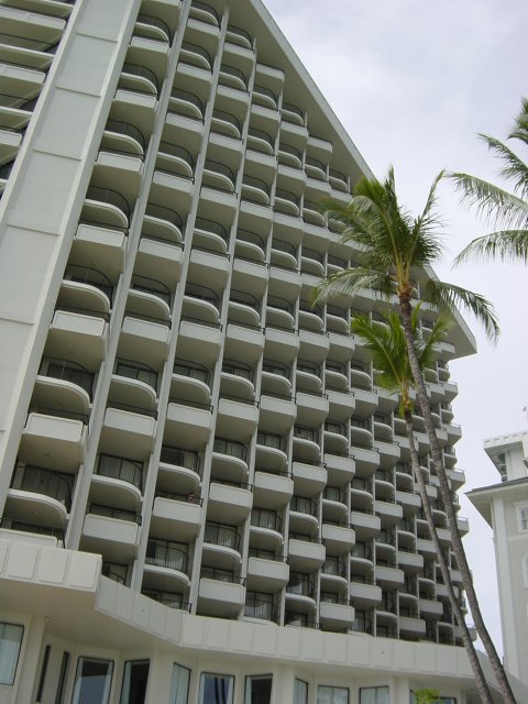 A tall hotel by the beach, perspective effect with balconies