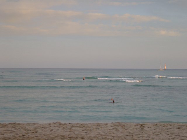 The beach, the ocean, waves and a boat