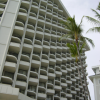 A tall hotel by the beach, perspective effect with balconies