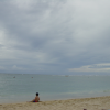 Little boy sitting near the water