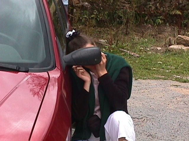 Coralie se fait une beaute rapidement devant le retroviseur de la 306
