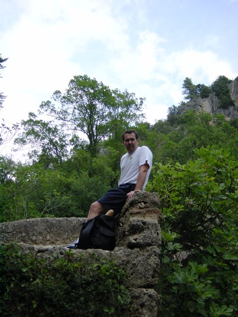 Daniel sitting on the edge of the bridge