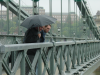 Daniel and Max on the Chain bridge and looking down on the Danube, Max looking as if about to spit