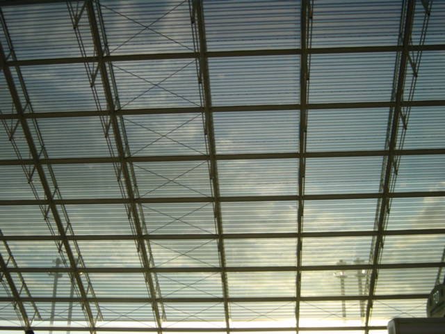 The ceiling: sky and clouds visible through