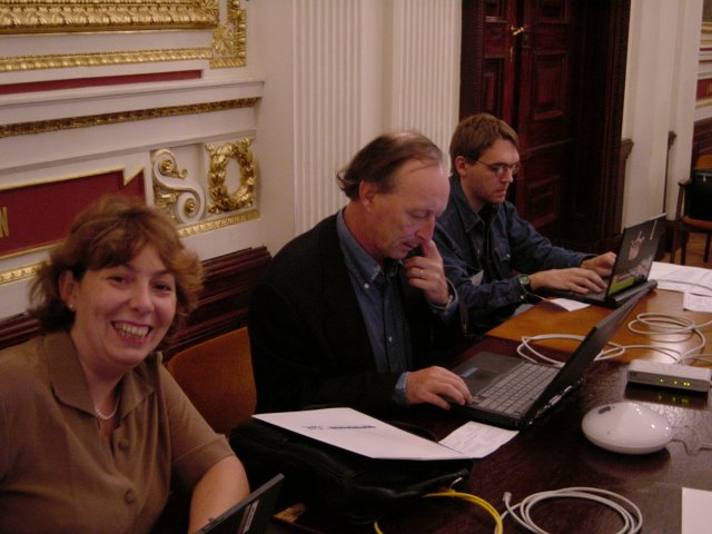 Marie-Claire, Vincent, Max, at the laptop table in the room of the event at Budapest Science Academy