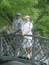 Dean mimicking the bronze man standing on the bridge