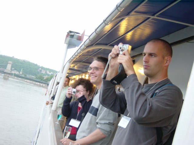 On the boat: Amy taking a photograph, Max and Dean very concentrated on his digital camera's screen