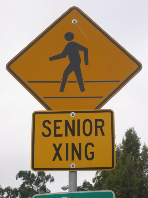 Seniro crossing road sign