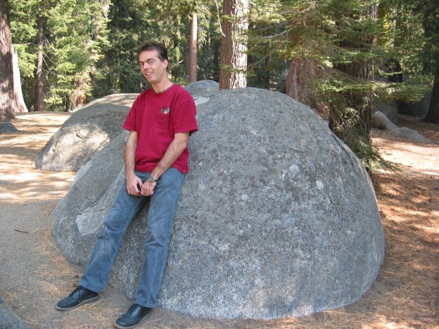 Steph leaning on a round rock