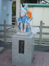 Stone fox in front of the train station (it is dressed and decorated)