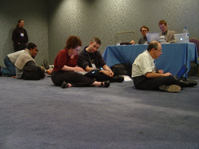 A lot of the staff sitting on the floor in the foyer and mostly working