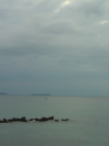 Cloudy morning: Iles Sainte-Marguerite and Saint-Honorat in the background, fishing boat and rocks in the water
