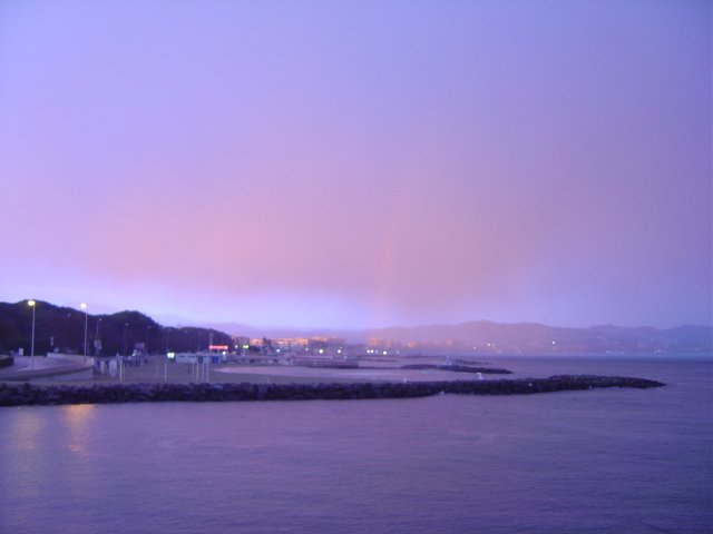 Rainbow and rosy colour sunset after a rainy day