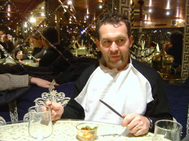 Daniel holding knife and fork, expecting dinner
