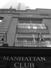 Manhattan Club and tall building above