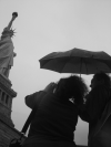 Amy photographying the statue while Maxf holds the umbrella over her