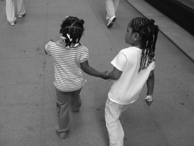 Little girls walking in the street