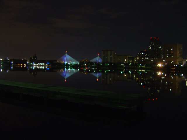 Zakim Bridge at night over very still water