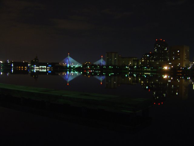 Zakim Bridge at night over very still water