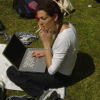 Coralie smoking and typing, campsite, Matamata