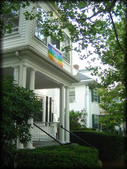 Peace flag above the entrance of a large white house