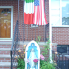 Madonna and Italian and American flags in the front of a house 