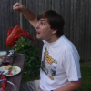 Philippe holding a lobster by the antenna and making faces at it