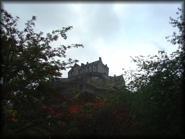 Edinburgh Castle above trees in Princes Street Gardens