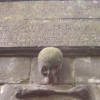 Carved plaque and stone skull