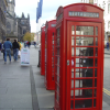 Three red telephone booths on the Royal Mile