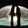 ericP and I kissing in front of a brightly lit fountain, Monaco