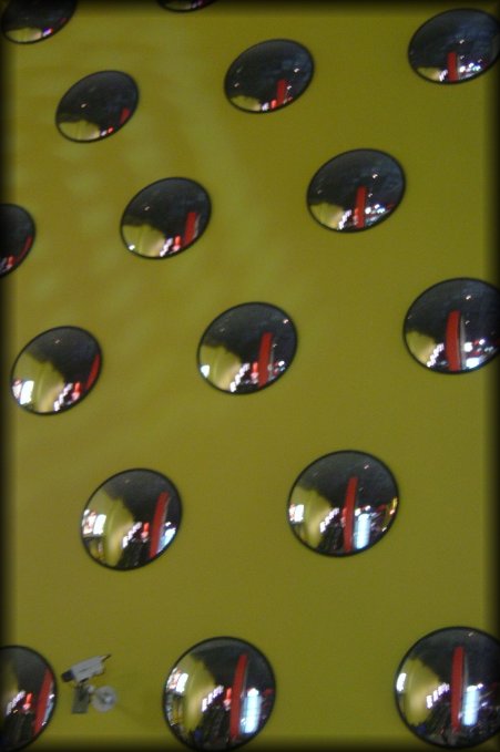 A yellow wall in the theater was covered with those mirrors.