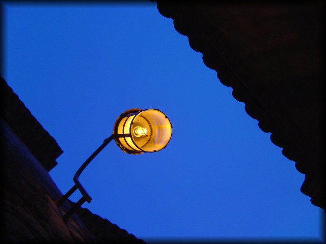 Orange light on a dusk blue sky