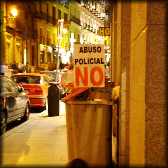 After a demonstration a poster reading "Abuso Policial NO" has been planted in a trash can