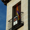 Flag and poster "NO a la GUERRA" on a balcony