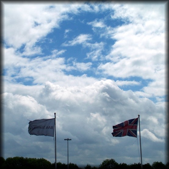 At Stansted airport between two flights. Flags against the sky.
