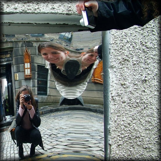 Distortion mirror, Camera Obscura. Coco crouching, flying two-headed Alex, Amy's hand holding her camera