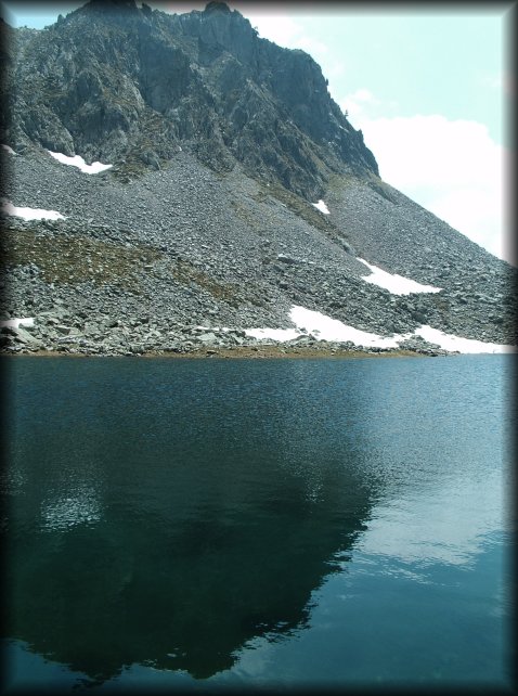 Reflection of the mountain in the blue/green water of the lake.